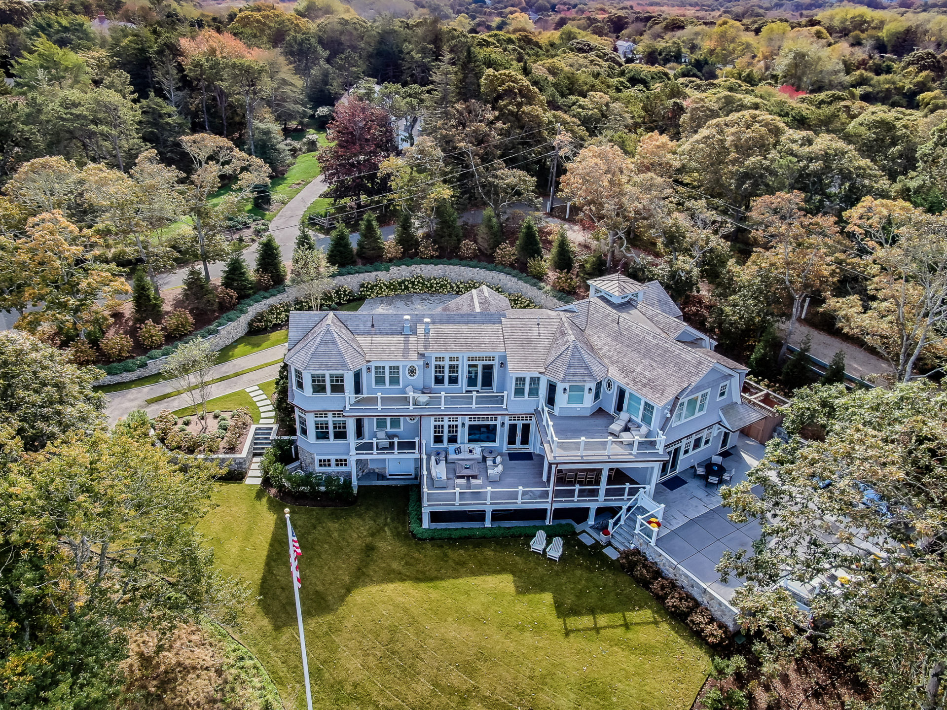 Aerial (drone) view of the back of a 2-story colonial style home in North Chatham, MA.