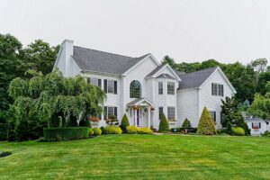 Image of the front of a 2-story colonial style home in West Bridgewater, MA.
