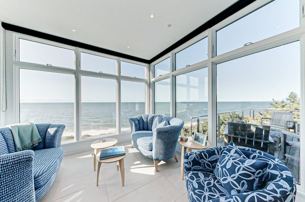 Digital image of a sitting room in a house overlooking the beach showing how professional home staging can make buyers fall in love with your home or listing